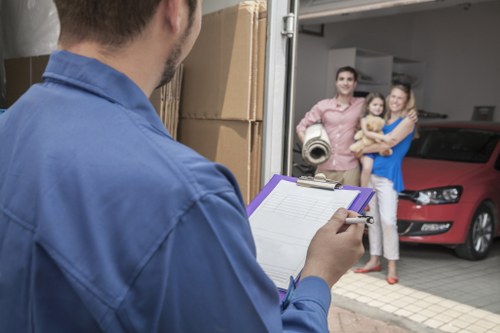 Careful piano transport with protective wrapping and moving equipment