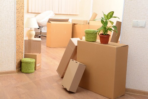 Professional movers handling a move with safety equipment