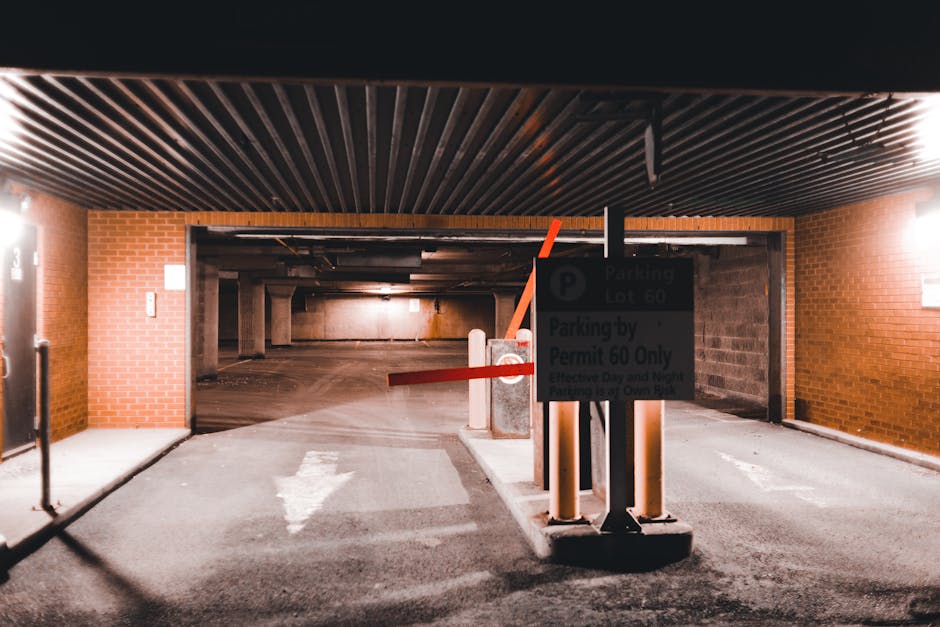 Four blue parking permit signs mounted on black metal poles positioned against a vertically corrugated metal wall. The signs display a large white letter 'P' with additional text including 'vergunninghouder' and 'AUTODATE' underneath. The signs are aligned in a row, with the largest sign in the center and smaller signs to the left and right, indicating designated parking areas for vehicle loading or moving purposes. The environment suggests an urban setting, possibly near a commercial or industrial building, relevant to house removals or moving logistics. As part of the home relocation process, these parking permits support parking management during furniture transport or packing and moving activities, with signage from Man and Van Bounds Green visible in the context of residential relocations within the Bounds Green area, as per the associated webpage.